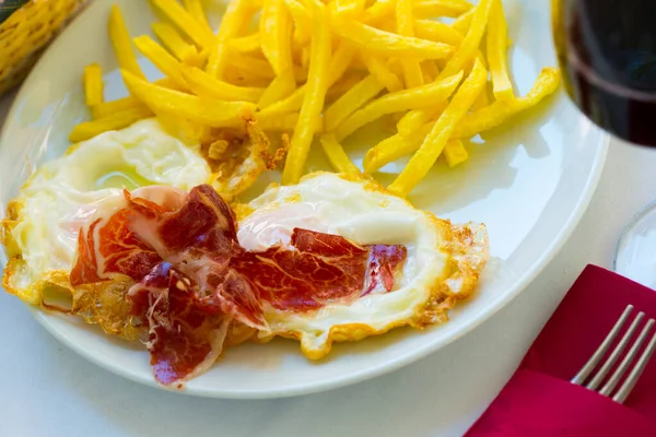 Ovos fritos espanhóis com batatas, presunto e vinho — Fotografia de Stock