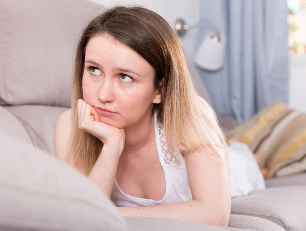 Young female is thoughtful and bored alone — Stock Photo, Image