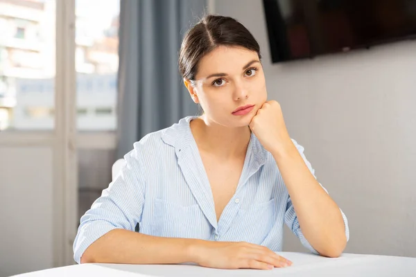 Porträt eines traurigen Mädchens, das zu Hause im Wohnzimmer sitzt — Stockfoto