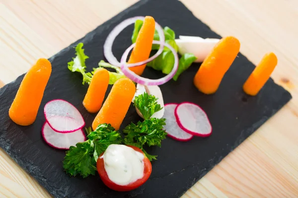 Close up of tasty dish of fresh vegetables and carrot dominant served — Stock Photo, Image