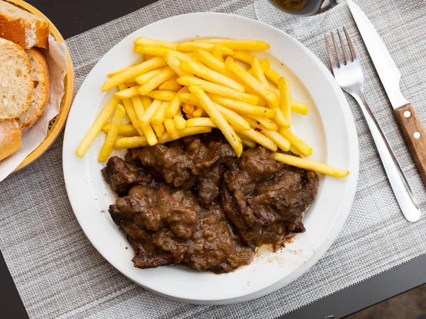 Delicious stewed veal with sauce, served with French fries — Stock Photo, Image