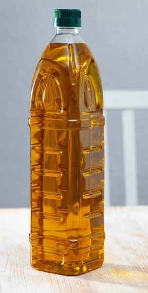 Vegetable oil on wooden table — Stock Photo, Image