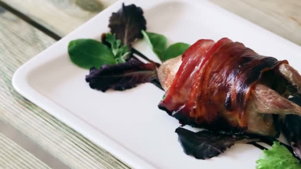 Wrapped in bacon baked quail served on plate seasoned with balsamic sauce — Stock Video