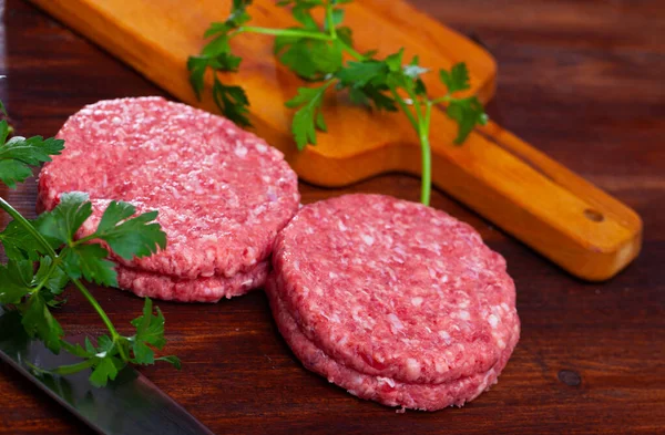 Cooking ingredients, raw burger cutlets — Stock Photo, Image