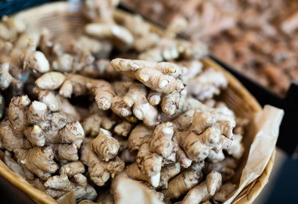 Ginger root on showcase of greengrocery shop for sale to customers — Stock Photo, Image