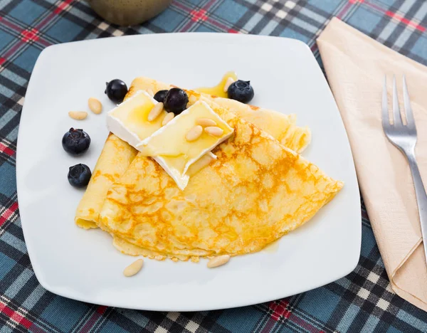 Appetizing pancakes with cheese, honey and nuts — Stock Photo, Image