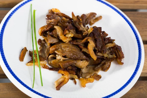 Tasty cooked fried oyster mushrooms at plate at table — Stock Photo, Image