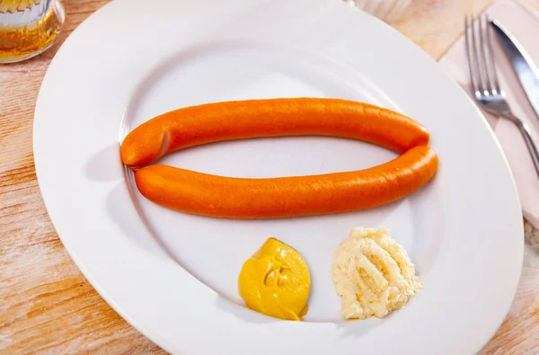 Two vienna sausages with mustard and horseradish on plate — Stock Photo, Image