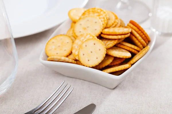 Appetizing crackers in a plate on the table — стоковое фото