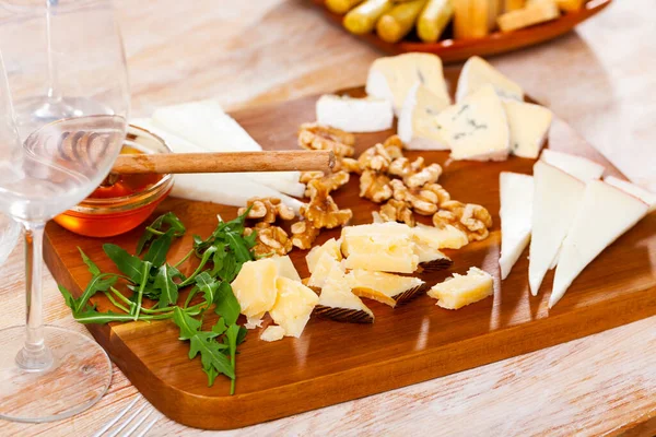 Various types of cheese on wooden board — Stock Photo, Image