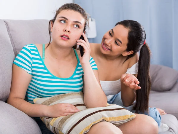 Girl eavesdropping phone conversation of friend — Stock Photo, Image