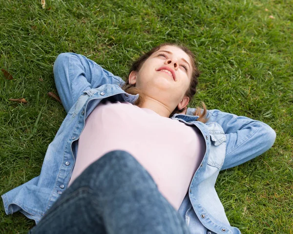 Portrait of teenager while lying in summer green park — Stock Photo, Image