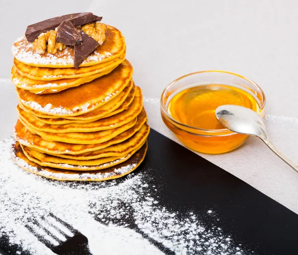 Stack Warm Pancakes Chocolate Nuts Served Honey Glass Bowl — Stock Photo, Image