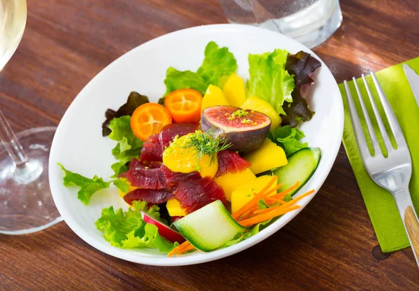 Healthy salad with fresh tuna, vegetables and fruits