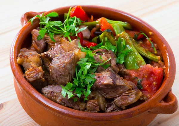 Appetizing stew meat with vegetables served in clay pot