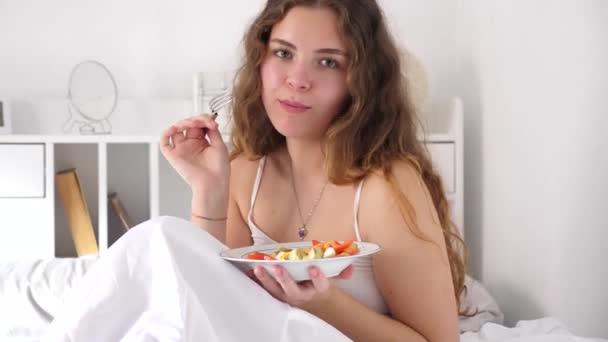 Χαρούμενο Κορίτσι Που Απολαμβάνει Πρωινό Του Σαββατοκύριακου Τρώγοντας Φρέσκια Σαλάτα — Αρχείο Βίντεο