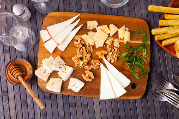 Varieties Cheese Sliced Served Wooden Board Walnuts Honey — Stock Photo, Image