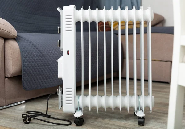 Electric oil-filled radiator heater for home on floor at room