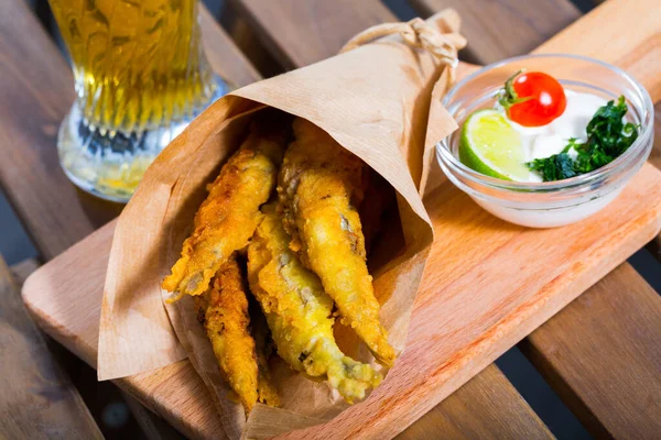 Fried Battered Sprats Greens Creamy Cheese Sauce Served Wooden Cutting — стоковое фото