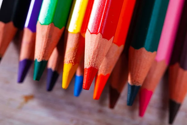 Picture of multicolored pencils on wooden background