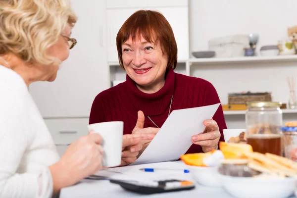 Χαμογελώντας Συνταξιούχοι Γυναίκες Στο Τραπέζι Λογαριασμούς Κοινής Ωφέλειας Στο Σπίτι — Φωτογραφία Αρχείου
