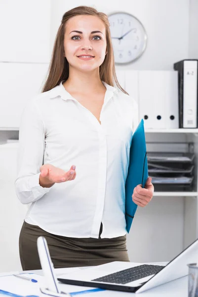 Young woman is meeting new client with folder in office.