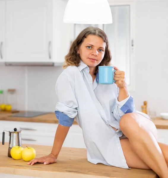 Cheerful Woman Mans Shirt Drinking Fresh Coffee While Sitting Kitchen — Stock Photo, Image