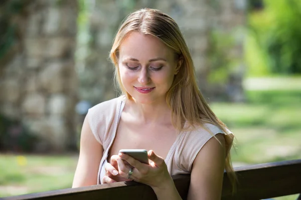 Portrait Blond Young Woman Looking Her Smartphone Garden Summer Day — Stockfoto