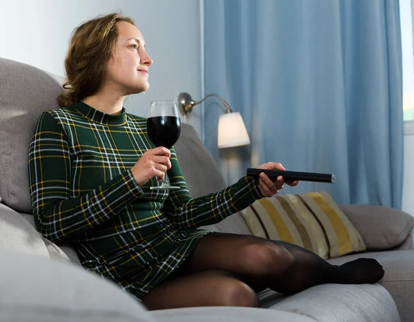Positive Girl Sitting Sofa Home Watching Holding Glass Red Wine — Stockfoto