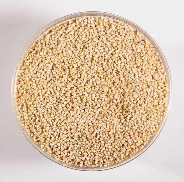 Top View Glass Bowl Raw Quinoa Seeds White Surface — Zdjęcie stockowe