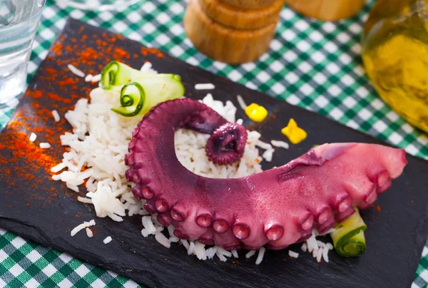 Delicious cooked octopus tentacles on a chopping board. High quality photo