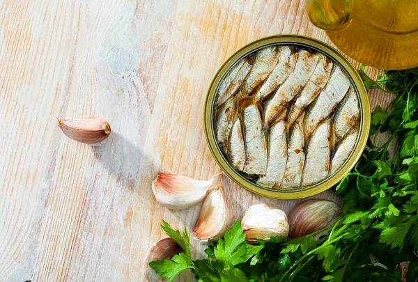 Open tin can with sardines in oil.