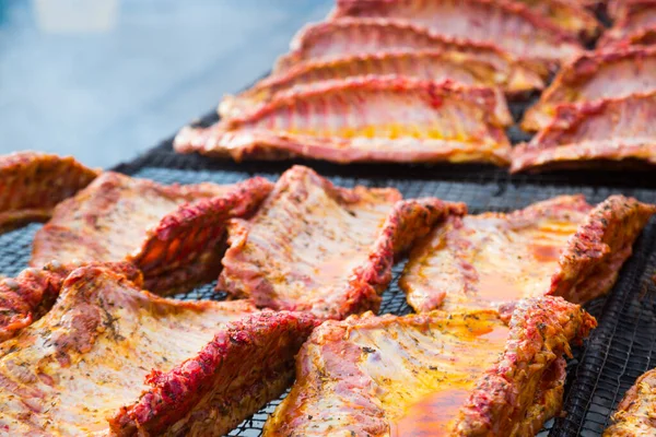 Meat ribs of pig roasting on barbecue grill for summer picnic