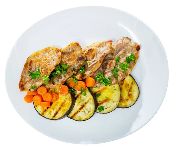 Delicious grilled marinated mutton chops with roasted eggplant and carrot. Isolated over white background