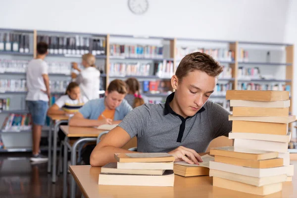 Aufgebrachter Schüler Sitzt Mit Bücherstapel Bibliothek — Stockfoto