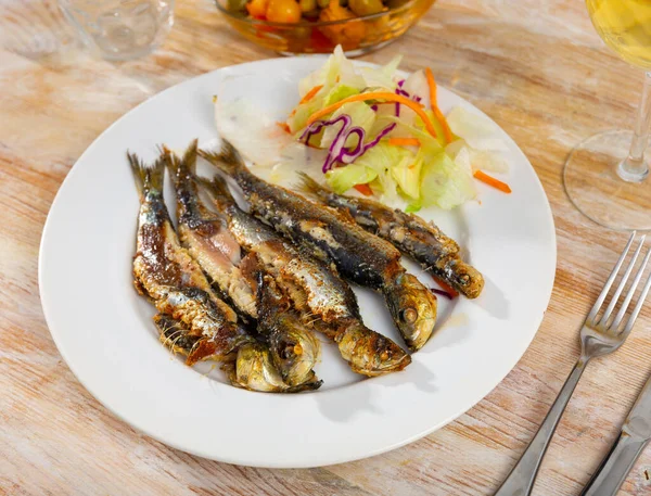 Delicious grilled sardines with a light vegetable salad of cabbage and carrots