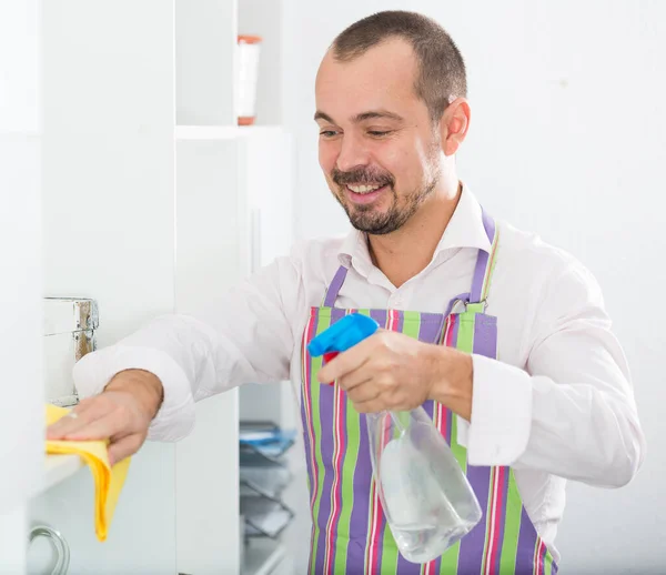 Positive Young Man Apron Cleaning Office Shelves Papers Cleanser — Stock Photo, Image