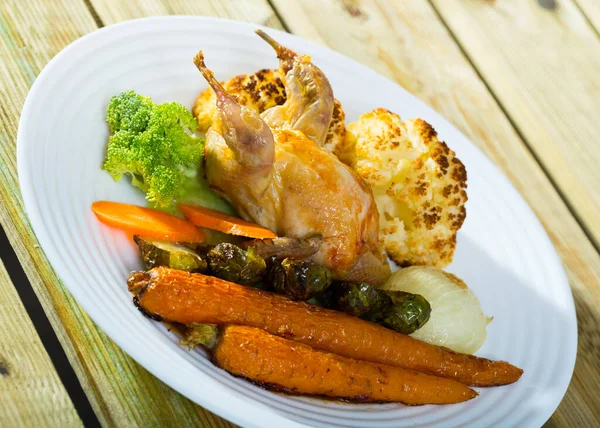 Delicious poultry dish - partridge baked with vegetables in honey-mustard sauce