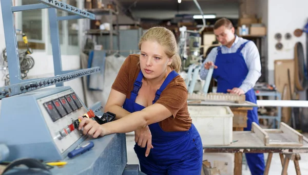 ガラス面取り機の調整に従事するガラス工場の経験豊富な女性労働者 — ストック写真