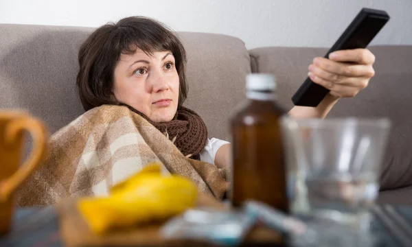 Sick Woman Wrapped Blanket Holding Remote Control Home — Stock Photo, Image