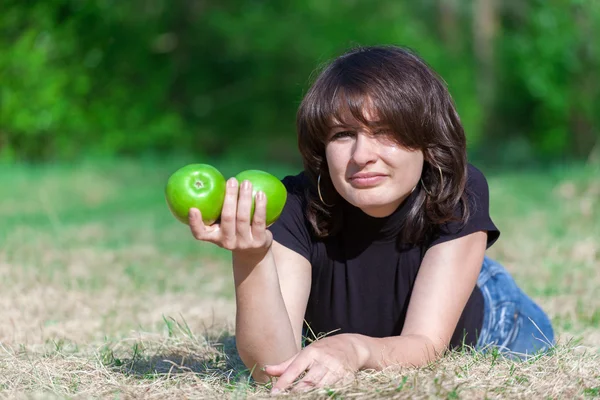 Young girl holding two apples in my right hand — Stock Photo, Image