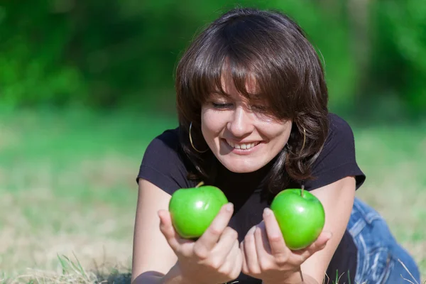 Beautiful young girl with two apples in hands Royalty Free Stock Images