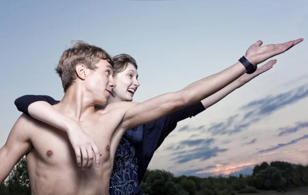 The young man and the girl pull hands upwards — Stock Photo, Image