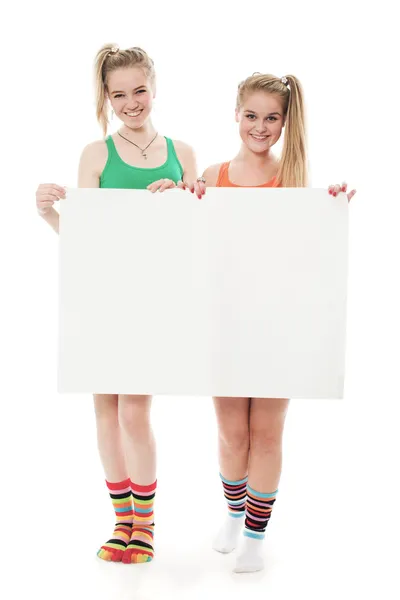 Two cheerful girls hold the form — Stock Photo, Image