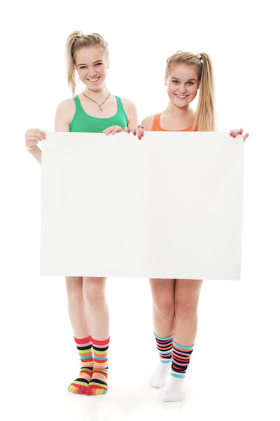 Two cheerful girls hold the form