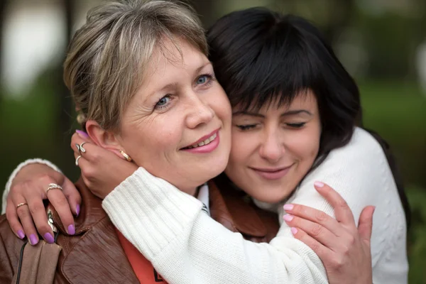 The girl embraces and kisses the woman — Stock Photo, Image