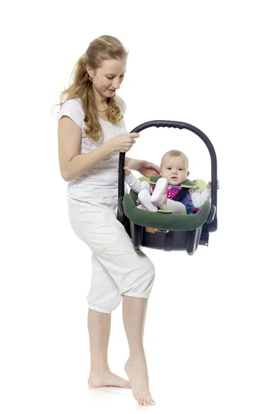 The young woman holds the babe in a cradle — Stock Photo, Image