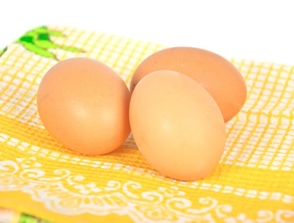 Eggs on yellow tablecloth — Stock Photo, Image