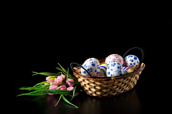 Easter eggs in wicker basket — Stock Photo, Image