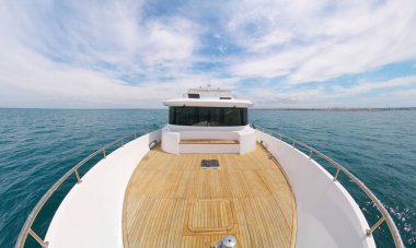 Yacht panorama on deck. Calm sea water at day. Modern and luxury transportation.